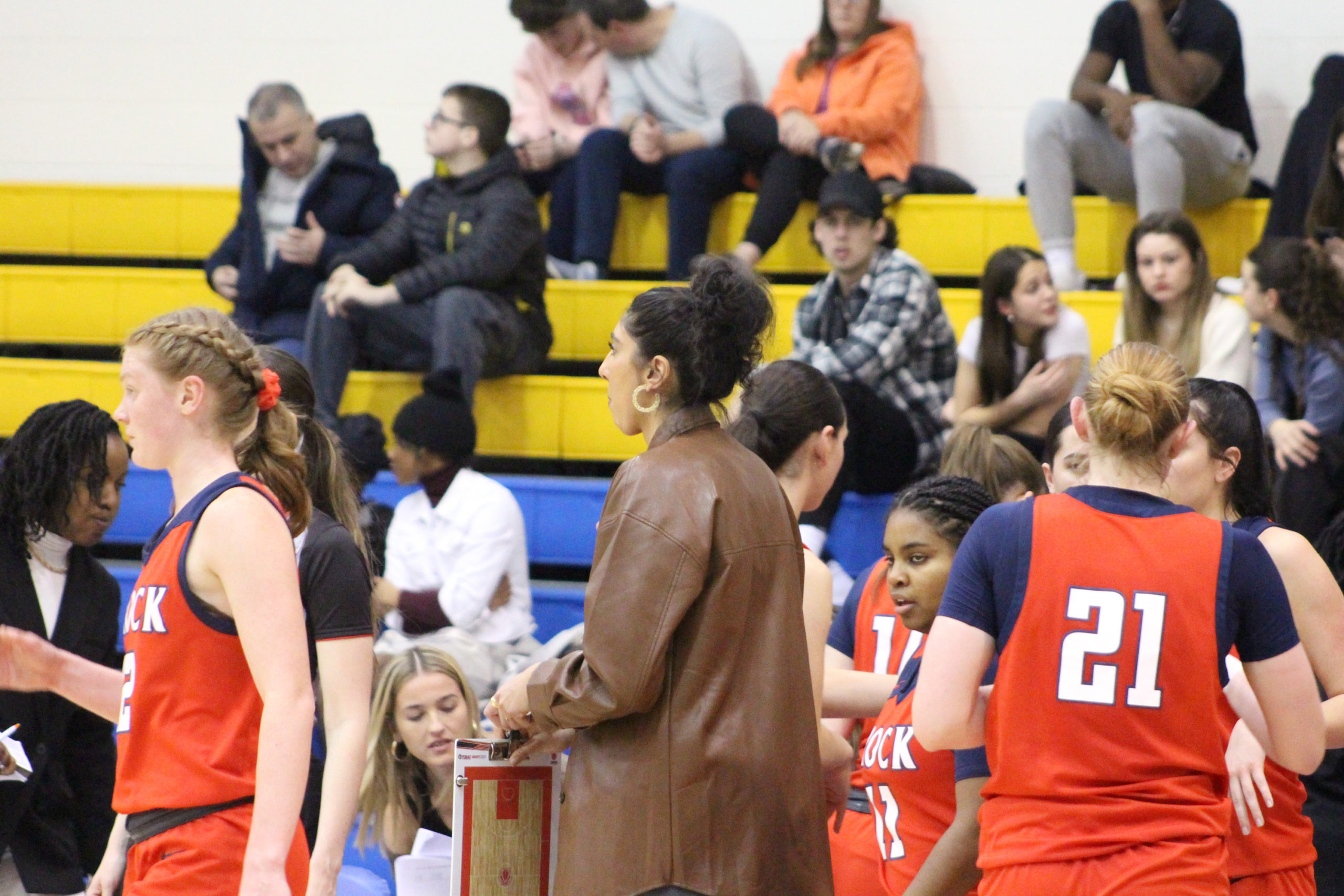 Shae Dheensaw holds a clipboard at the Brock Badgers bench at the MAC