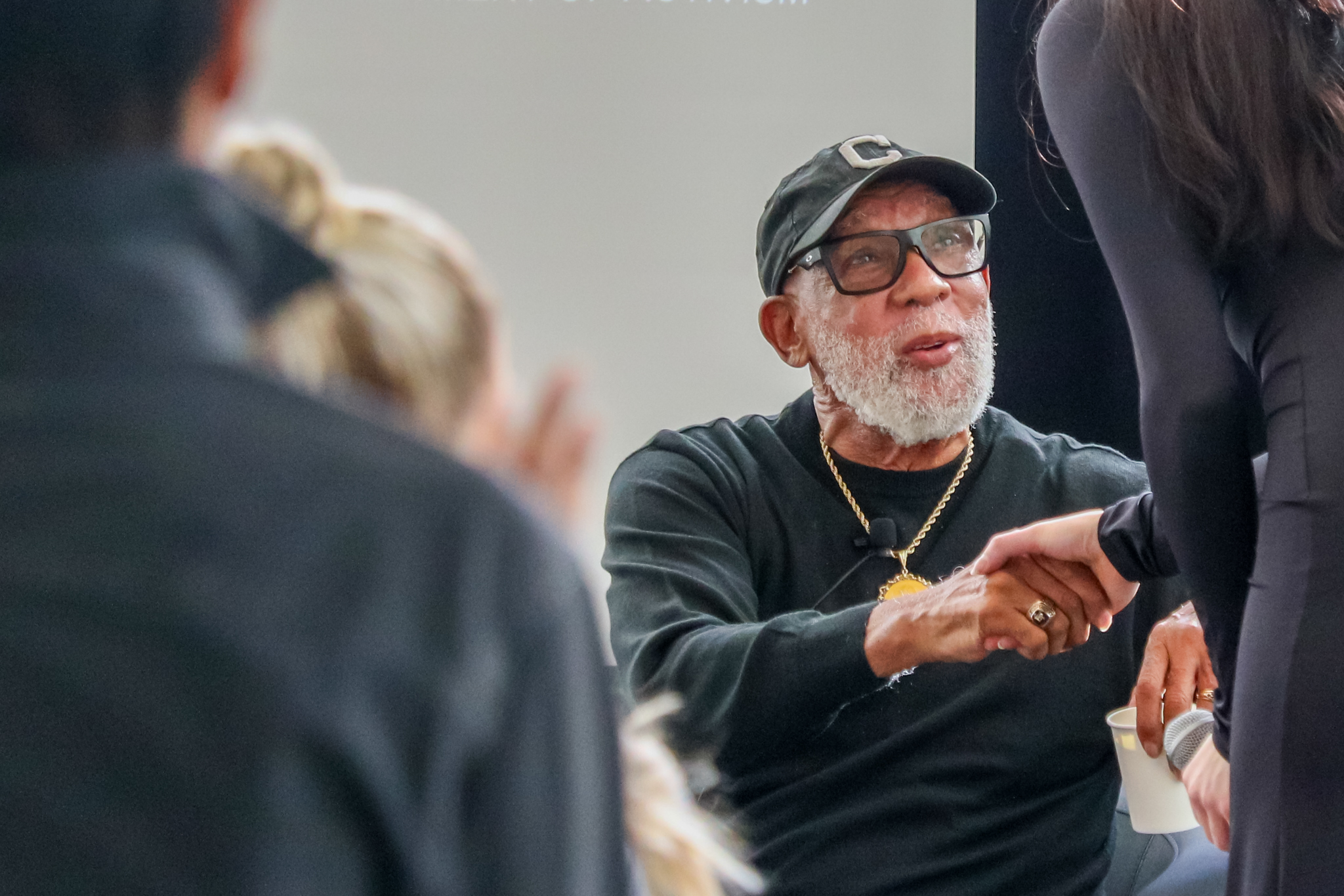 John Carlos shakes hands with people