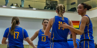 The TMU Bold women's going back to the centre of the court in a game against Carleton